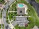 Aerial view of the community clubhouse, pool, hot tub, parking, and pond at 29704 Niagara Court, Englewood, FL 34223