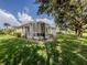 Screened-in back patio perfect for enjoying the outdoors with a grill and relaxing seating area at 29704 Niagara Court, Englewood, FL 34223