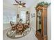 Cozy dining area with a glass table, wicker chairs, and decorative rug at 29704 Niagara Court, Englewood, FL 34223