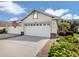 Charming home featuring a three car garage, manicured landscaping, and an inviting entrance at 29704 Niagara Court, Englewood, FL 34223