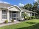 Well-maintained home with screened entry, complemented by lush landscaping and a brick walkway at 29704 Niagara Court, Englewood, FL 34223