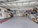 Spacious three car garage with ample storage and epoxy flooring at 29704 Niagara Court, Englewood, FL 34223