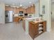 Spacious kitchen featuring stainless steel appliances, wooden cabinets, and a bright counter at 29704 Niagara Court, Englewood, FL 34223