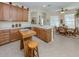 Charming kitchen featuring wood cabinetry, island, and breakfast nook with dining area at 29704 Niagara Court, Englewood, FL 34223