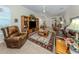 Cozy living room featuring tile floors, ceiling fans, and comfortable leather furniture at 29704 Niagara Court, Englewood, FL 34223