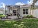 Inviting screened-in porch with comfortable seating overlooking the landscaped backyard at 29704 Niagara Court, Englewood, FL 34223
