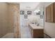 Bathroom features shower-tub combo, single sink vanity, tile flooring, and neutral paint at 3199 Elkrem Ave, North Port, FL 34286