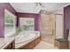 Bright bathroom featuring a tub next to a window and a glass door shower at 3199 Elkrem Ave, North Port, FL 34286