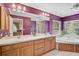 Large primary bathroom with double sinks, tub, and walk-in shower at 3199 Elkrem Ave, North Port, FL 34286