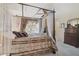 Bedroom with four poster bed and window with decorative drapes at 3199 Elkrem Ave, North Port, FL 34286