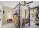 Bright bedroom featuring a four poster bed and large window at 3199 Elkrem Ave, North Port, FL 34286