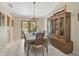 Traditional dining room features tile flooring, chandelier, and french doors to outdoor living space at 3199 Elkrem Ave, North Port, FL 34286