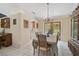 Traditional dining room features tile flooring and chandelier; kitchen visible in background at 3199 Elkrem Ave, North Port, FL 34286
