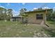Exterior of the home featuring a screened in porch, and landscaped backyard at 3199 Elkrem Ave, North Port, FL 34286
