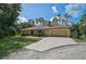 Inviting single-story home featuring a well-maintained front lawn, landscaping, and long driveway at 3199 Elkrem Ave, North Port, FL 34286