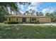 Inviting single-story home featuring a well-maintained front lawn and manicured landscaping at 3199 Elkrem Ave, North Port, FL 34286