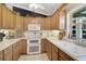 Charming kitchen features double oven, white appliances, light wood cabinets, and window over sink at 3199 Elkrem Ave, North Port, FL 34286