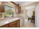 Kitchen features stainless steel dishwasher, double sink, and view to trees outside the window at 3199 Elkrem Ave, North Port, FL 34286