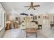 Bright and airy living room featuring tiled floors, vaulted ceiling and a cream colored sofa at 3199 Elkrem Ave, North Port, FL 34286
