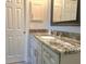 Bathroom featuring granite vanity, modern fixtures, and ample cabinet space at 333 The Esplanade N # 102, Venice, FL 34285