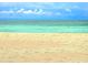 Sandy beach view with an ocean backdrop perfect for relaxation at 333 The Esplanade N # 102, Venice, FL 34285