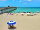 Picturesque beach scene with a pier, clear turquoise water, and people enjoying a sunny day at 333 The Esplanade N # 102, Venice, FL 34285