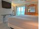 Bedroom featuring a large sliding glass door with views, white storage, and a wall-mounted TV at 333 The Esplanade N # 102, Venice, FL 34285