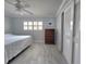 Cozy bedroom features a ceiling fan, closet with louvered doors, and a dresser at 333 The Esplanade N # 102, Venice, FL 34285