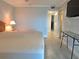 Bedroom with view to hall, exterior doors, modern floors, and a wall-mounted TV at 333 The Esplanade N # 102, Venice, FL 34285