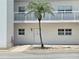 Condo exterior with updated landscaping, modern railings, and updated accessibility at 333 The Esplanade N # 102, Venice, FL 34285
