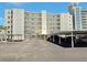 Exterior view of the building featuring ample parking and an architectural design at 333 The Esplanade N # 102, Venice, FL 34285