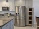 Bright kitchen with modern appliances, cabinets, and granite countertops at 333 The Esplanade N # 102, Venice, FL 34285