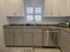 Charming kitchen featuring grey cabinets, granite counters, and stainless steel appliances at 333 The Esplanade N # 102, Venice, FL 34285