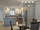 Open kitchen with pendant lighting, granite countertops, stainless appliances, and a dining area at 333 The Esplanade N # 102, Venice, FL 34285