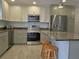 Updated kitchen featuring granite countertops and stainless steel appliances at 333 The Esplanade N # 102, Venice, FL 34285