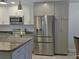 Modern kitchen with stainless steel appliances and granite countertops at 333 The Esplanade N # 102, Venice, FL 34285