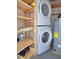Utility area features stacked washer and dryer and water heater at 333 The Esplanade N # 102, Venice, FL 34285