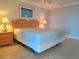 Inviting main bedroom with matching nightstands and lamps and an ocean themed painting at 333 The Esplanade N # 102, Venice, FL 34285