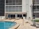 Community pool area includes tables and chairs for residents to relax and enjoy the weather at 333 The Esplanade N # 102, Venice, FL 34285