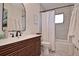 Modern bathroom featuring wood grain vanity, updated fixtures, a shower-tub combo, and contemporary finishes at 3340 Webber St, Sarasota, FL 34239