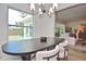 Elegant dining room area, next to the living room, illuminated with a modern chandelier at 3340 Webber St, Sarasota, FL 34239