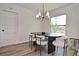 Bright dining room with modern lighting fixture and a large window with a view of the outdoors at 3340 Webber St, Sarasota, FL 34239