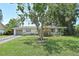 Inviting single-story home with a well-manicured lawn and mature trees creating a serene and picturesque setting at 3340 Webber St, Sarasota, FL 34239