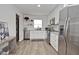 Modern kitchen with stainless steel appliances, white cabinets, and stylish countertops, creating a sleek design at 3340 Webber St, Sarasota, FL 34239