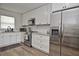 Modern kitchen with stainless steel appliances, white cabinets, and stylish countertops, creating a sleek design at 3340 Webber St, Sarasota, FL 34239