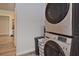 Laundry area with a modern, stacked washer and dryer set, providing convenience and efficiency at 3340 Webber St, Sarasota, FL 34239