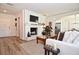 Charming living room with fireplace, modern decor, and an open view to the kitchen area at 3340 Webber St, Sarasota, FL 34239