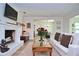 Warm living room showcasing the fireplace, wood floors and open layout at 3340 Webber St, Sarasota, FL 34239