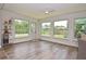 Sunroom offers natural light with multiple windows, backyard views, and a ceiling fan at 3340 Webber St, Sarasota, FL 34239