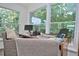 Sunroom filled with natural light from the surrounding windows, complete with work space at 3340 Webber St, Sarasota, FL 34239